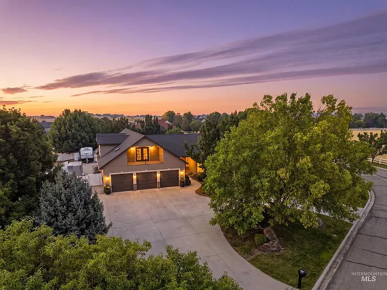 Raw listing photo of the property exterior at sunset